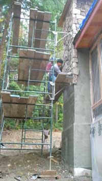 Applying 'Cultured Stone' to the chimney